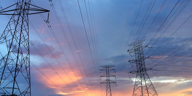electrical-wires-sunset Electric power towers on a sunset background